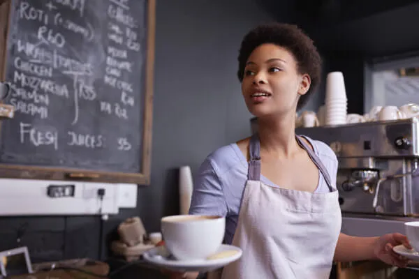 barista with coffee in cafe