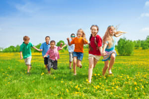 Kids running in grass - header