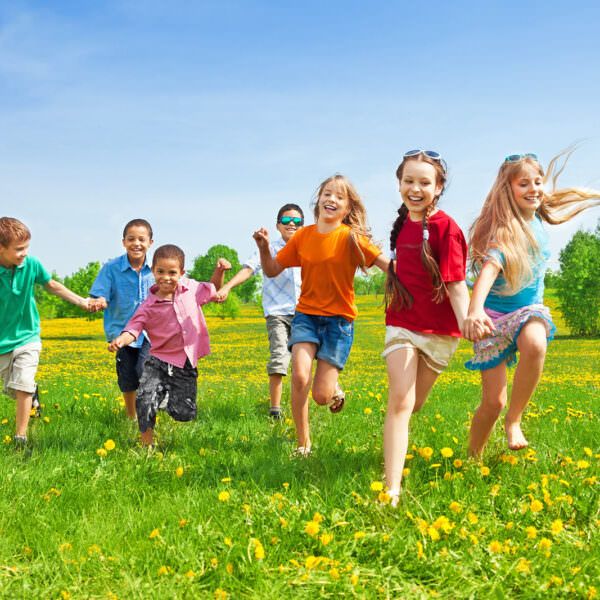 Kids running in grass - header
