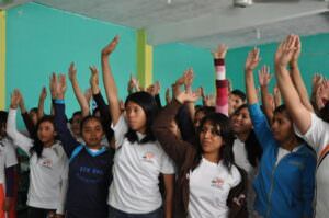 Students in Mexico raising their hands