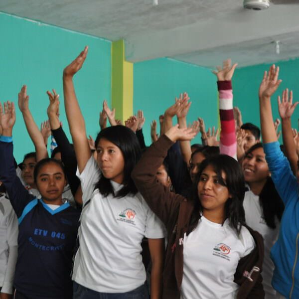 Students in Mexico raising their hands