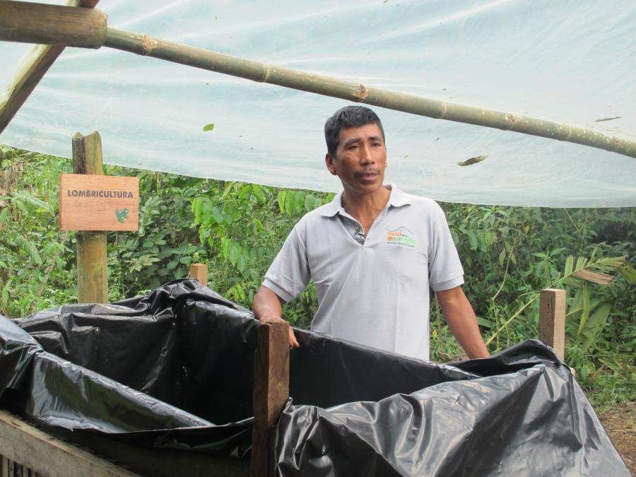 Community member shows vermiculture bin.