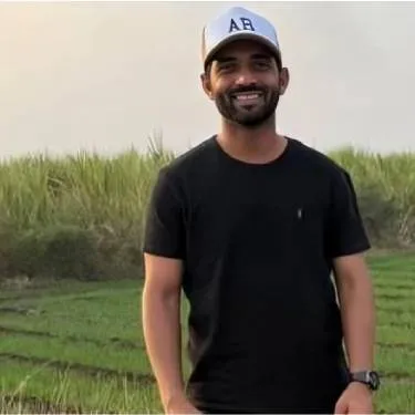 Man smiling and looking at the camera.