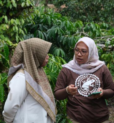 Two women talking on the field.