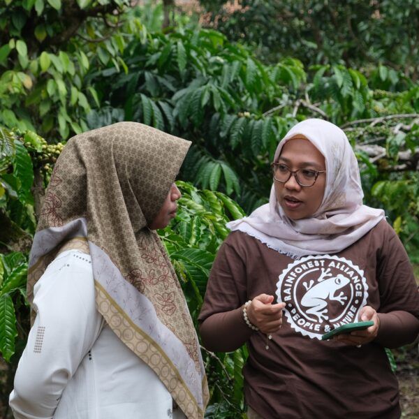 Two women talking on the field.