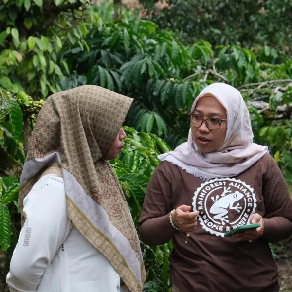 Two women talking on the field.