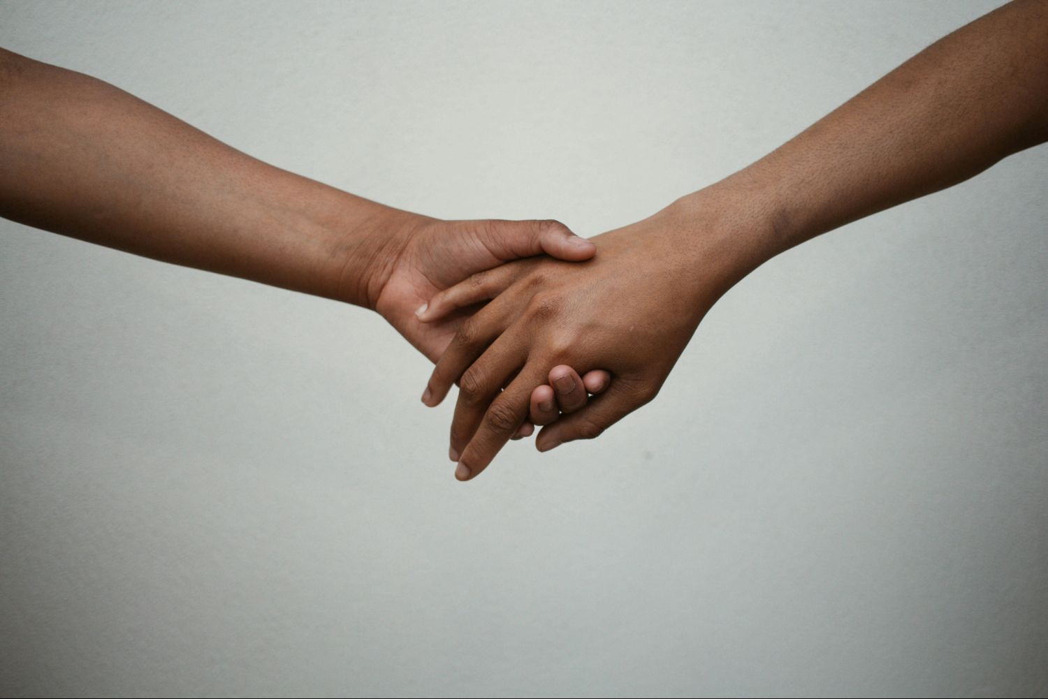Two hands holding each other.