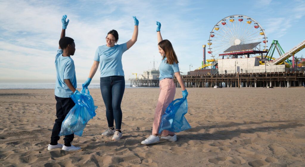 Teacher and students cleaning beach