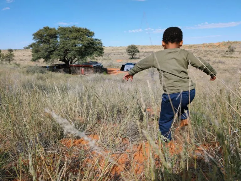 Child running through a field