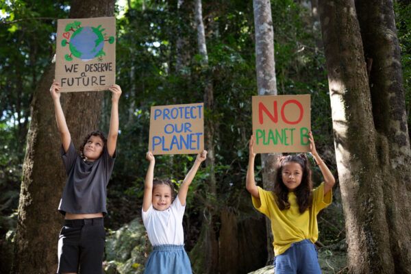 Kids holding signs to protect the planet