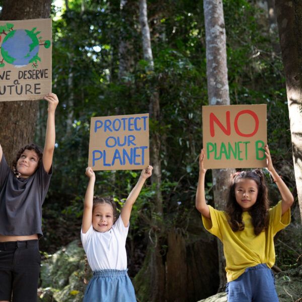 Kids holding signs to protect the planet