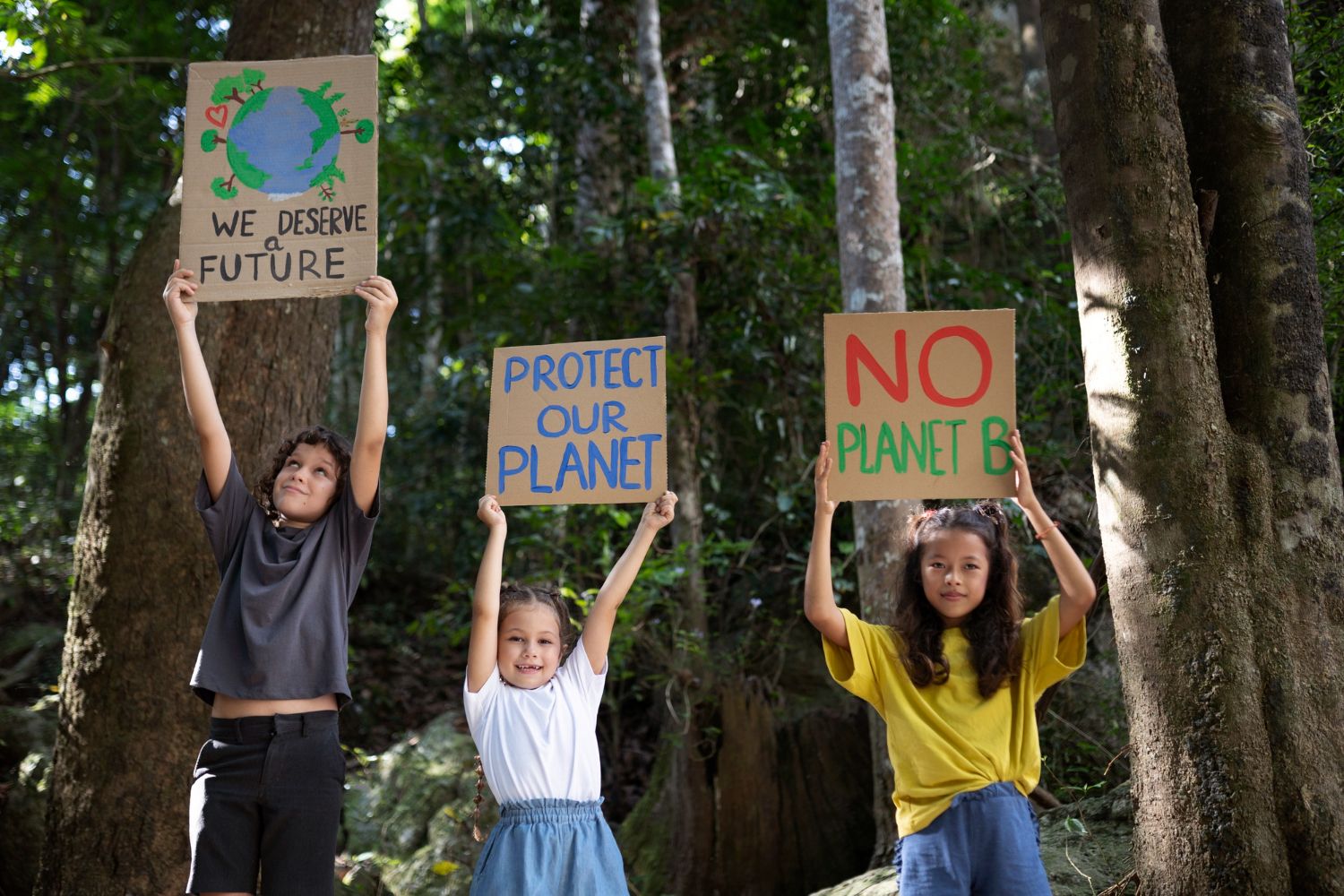 Kids holding signs to protect the planet