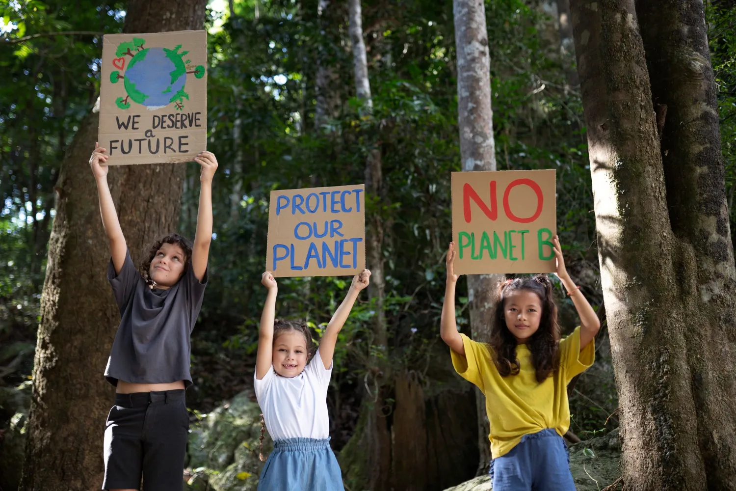 Kids holding signs to protect the planet